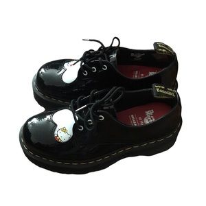 Size 7 women’s black and white Dr. Martens X Hello Kitty platform shoes.